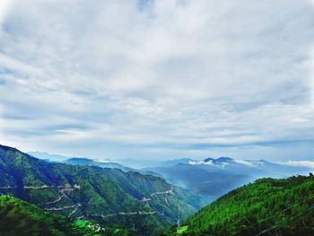 Scenic view of mountains against cloudy sky