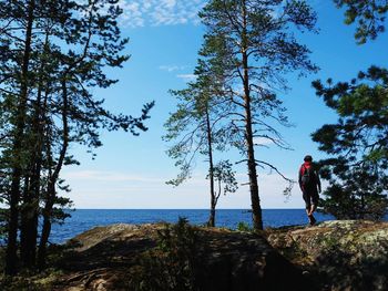 Man standing by sea against sky