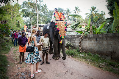 Rear view of people walking on road