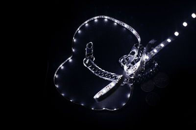 High angle view of illuminated lighting equipment against black background