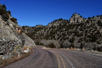 Road amidst mountain against clear sky