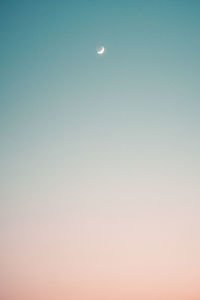 Low angle view of moon against clear sky at night