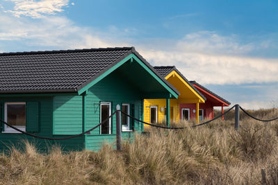 Houses on field against sky