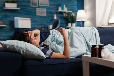 Midsection of man sleeping on sofa