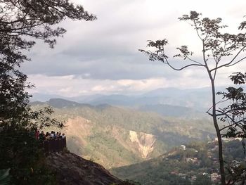 Scenic view of mountains against cloudy sky