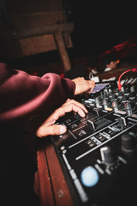 Cropped hand of man playing piano