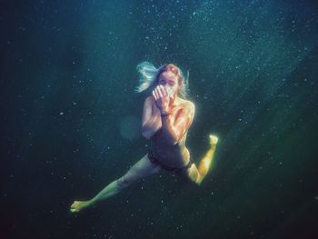 Low angle view of young woman against sky at night