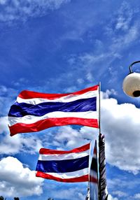 Low angle view of flag against blue sky