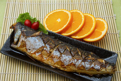 High angle view of fish on barbecue grill