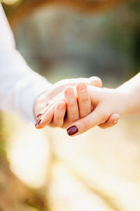 Cropped image of couple holding hands