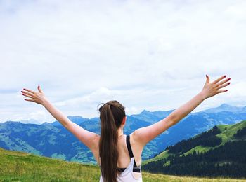 Rear view of woman standing on mountain