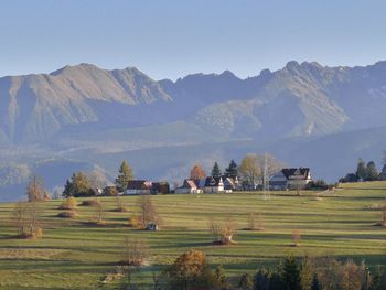 Scenic view of field and mountains against sky