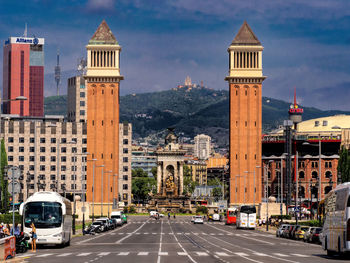 View of traffic on road by buildings in city