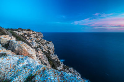 Scenic view of calm sea against blue sky