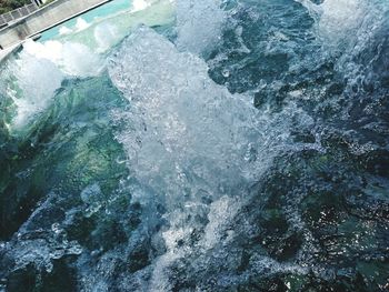 High angle view of waves splashing on rocks