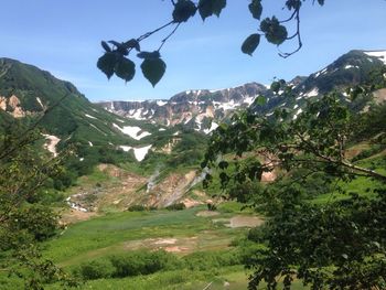 Scenic view of mountains against blue sky