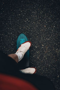 Low section of person standing on road