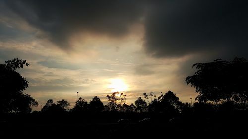 Silhouette trees against sky during sunset