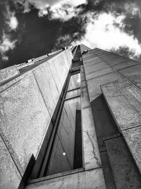 Low angle view of modern building against cloudy sky