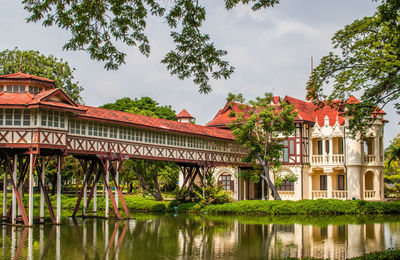 Building by lake against sky