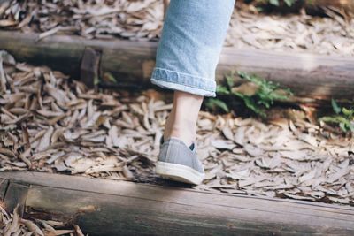 Low section of woman standing on wood