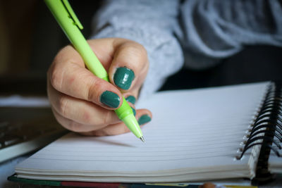 Cropped hand writing in book