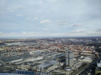 High angle view of cityscape against cloudy sky