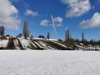 Snow covered field against sky