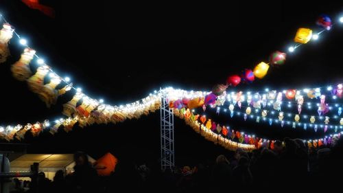 Group of people in illuminated building at night