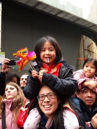 Portrait of happy young woman standing outdoors