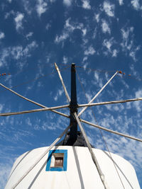 Low angle view of wind turbine against sky