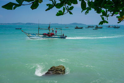 View of boats in sea against sky