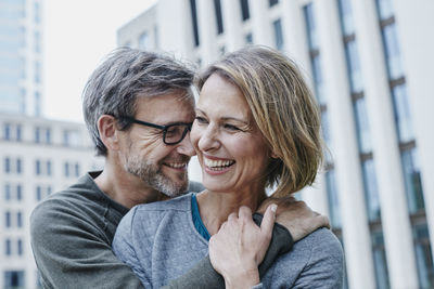 Happy mature couple hugging outdoors