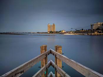 Bridge over river with city in background