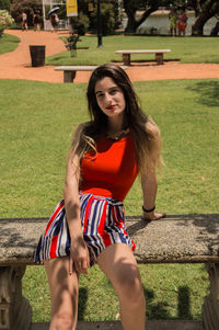 Portrait of beautiful young woman in field