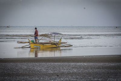 Man on beach against sky