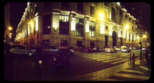 Illuminated city street at night