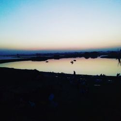 Scenic shot of calm lake at sunset