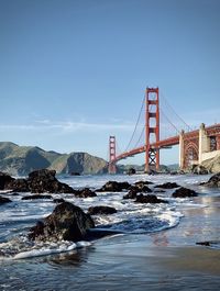 Golden gate bridge over bay against blue sky