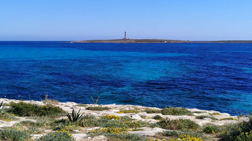 Scenic view of sea against clear blue sky