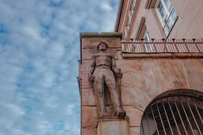 Low angle view of statue against building