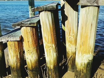 Close-up of wooden posts in sea