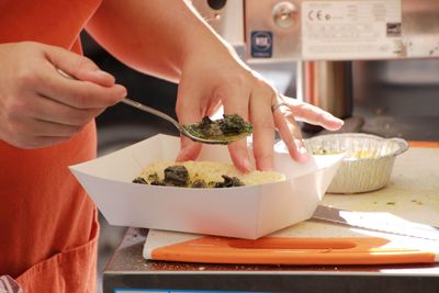 Midsection of woman preparing food at table