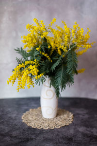 Close-up of yellow mimosa flower on table, women's day greeting