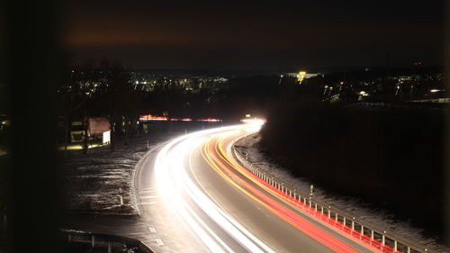 High angle view of light trails on road at night