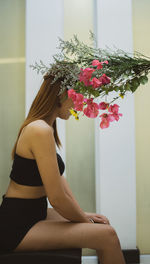 A woman sitting in red yellow flowers