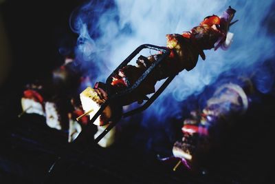 Close-up of food in skewers at night