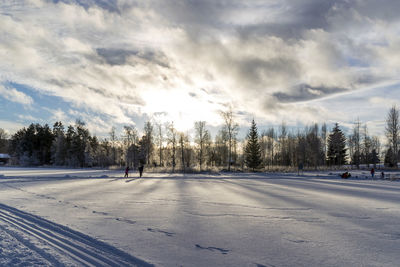 Scenic view of snow covered road against sky