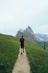 Man hiking at seceda in the dolomite mountains