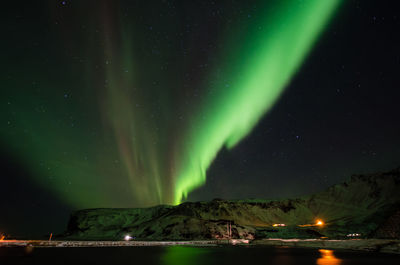 Scenic view of illuminated mountains against sky at night